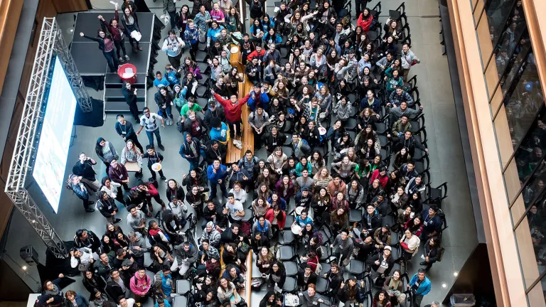 View looking down on people gathering in the Metro Center atrium lobby.