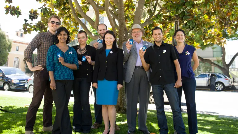 Representatives from local businesses show off their free AC Transit EasyPasses.