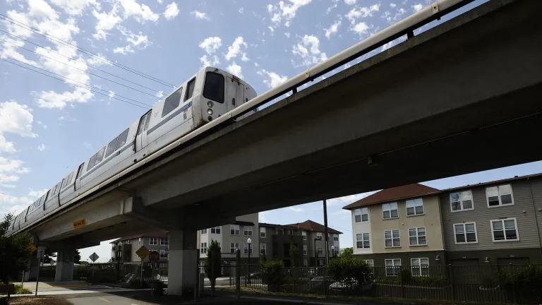 A BART train goes past multi-family homes near El Cerrito station.