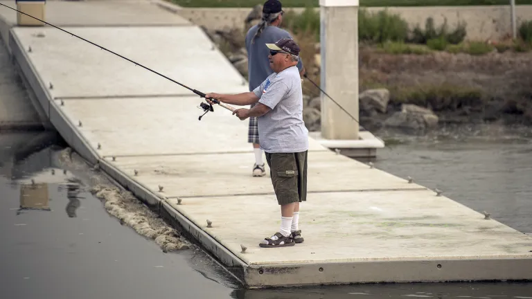  Two men fishing on a pier at Oro Loma/San Lorenzo Creek Levees.