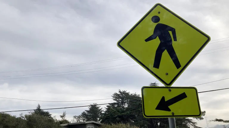 Yellow sign indicating a pedestrian crossing.