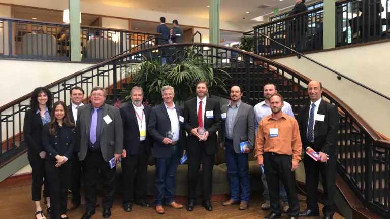 The I-580/Richmond-San Rafael Bridge Eastbound Third Lane Pilot Project team stands in front of the staircase at the Sheraton Hotel in Sacramento.