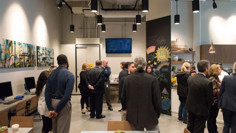 The Hub staff speak with visitors during the center's soft opening event. 