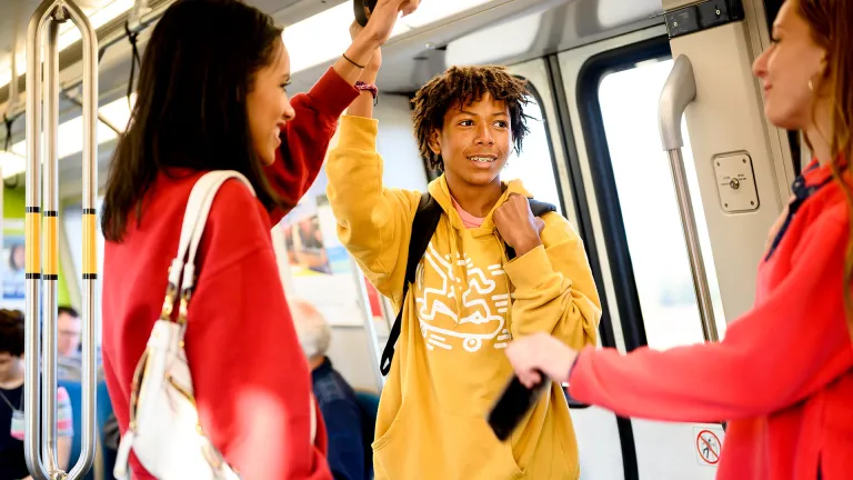 Happy teenagers riding BART.