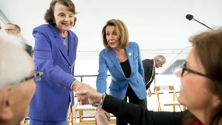 Dianne Feinstein and Nancy Pelosi greet the crowd. 