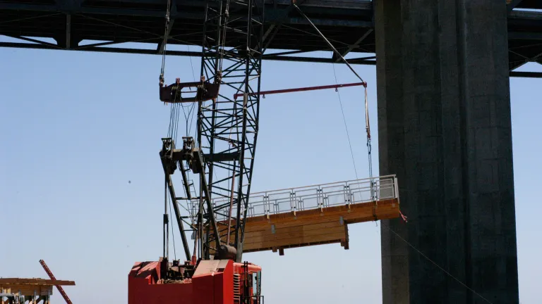 Crews prepare to install temporary bike path modules. 