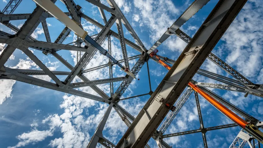 Low angle view of demolition of Bay Bridge East Span with beautiful blue skies above.