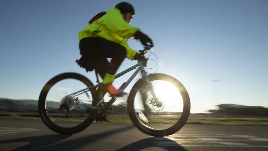 A cyclist zooms by.