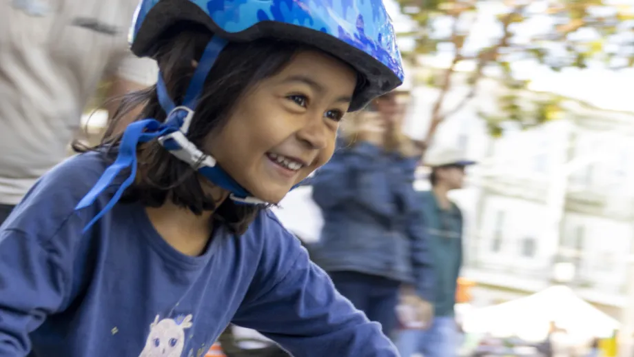 A new cyclist learning to ride at the Freedom from Training Wheels event in San Francisco on Bike to Wherever Days 2026.