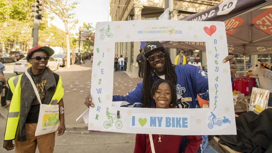 People with an "I heart my bike" sign at the Oakland Bike Happy Hour on Bike to Wherever Days 2026.