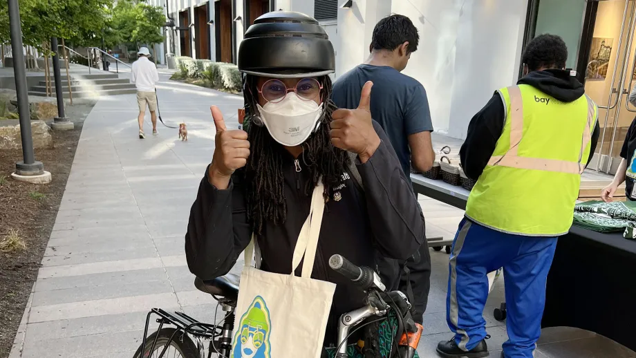 A cyclist giving a thumbs-up on Bike to Work Day.