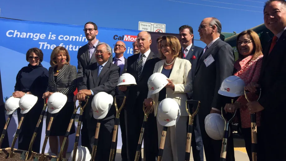 group of elected officials holding hard hats