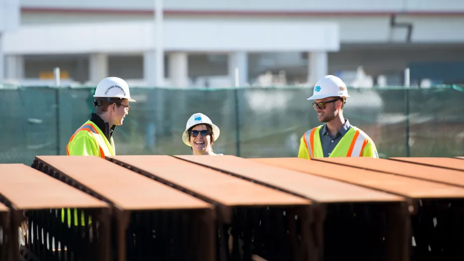 construction workers standing in front of steal beams