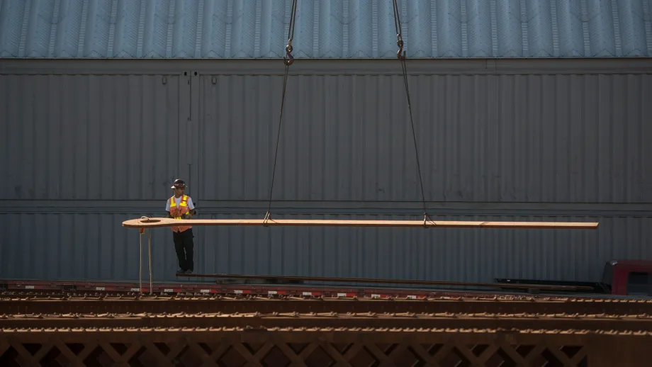 construction worker standing in front of steal beams
