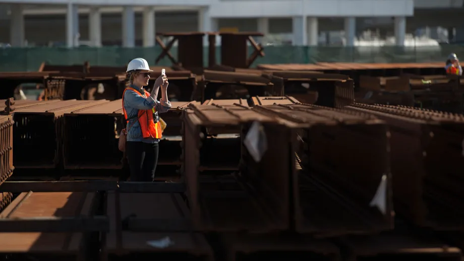 construction worker standing in front of steal beams