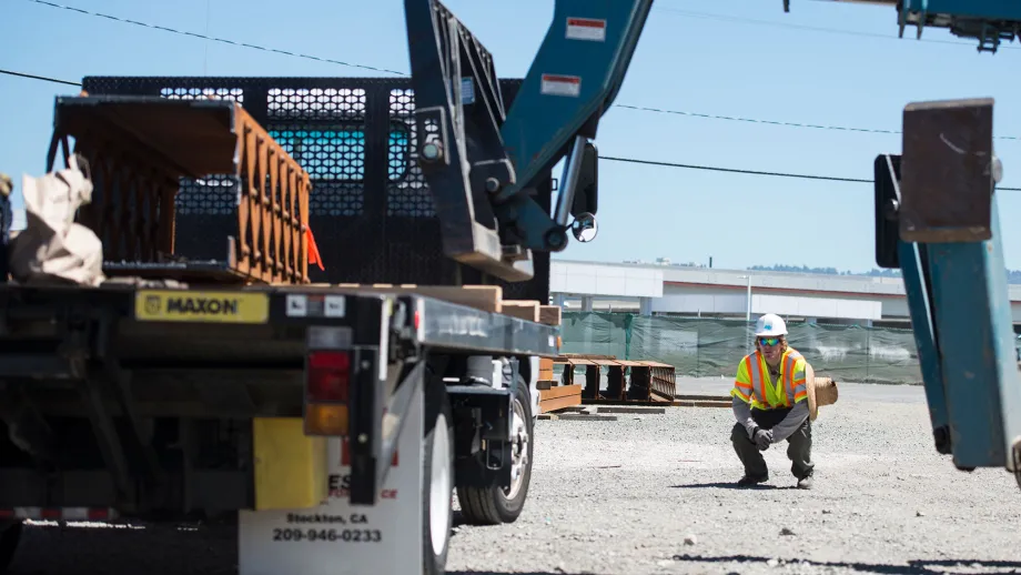 construction worker watching crane