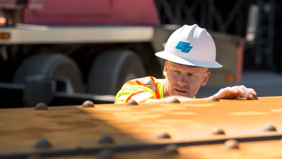 construction worker looking at steel beam