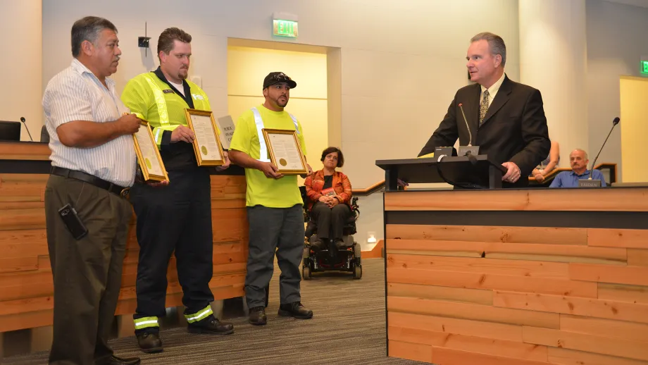 Freeway Service Patrol tow truck drivers Moises Reyes and Darryl Poe, and Waste Management of Alameda County driver David Garcia receive their awards from MTC Chair Dave Cortese