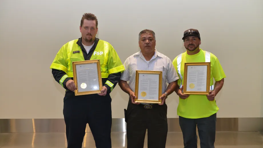 men holding their awards