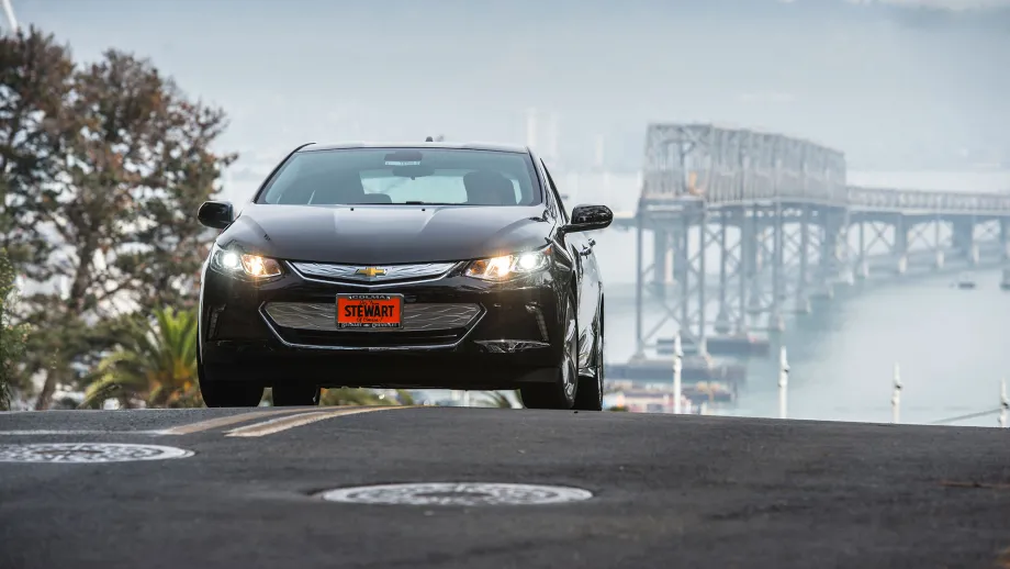 electric car with bridge in background 