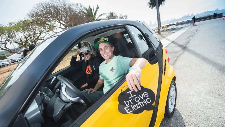 two men riding in an electric car