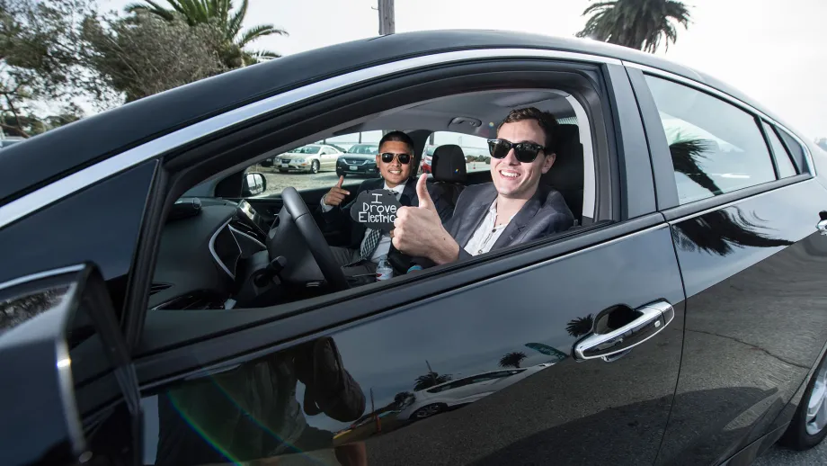 two men riding in an electric car