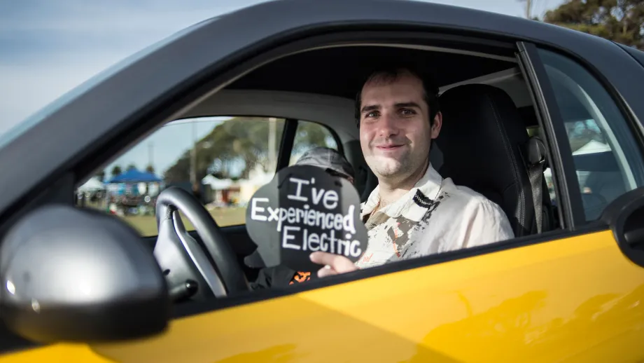 man sitting in an electric car