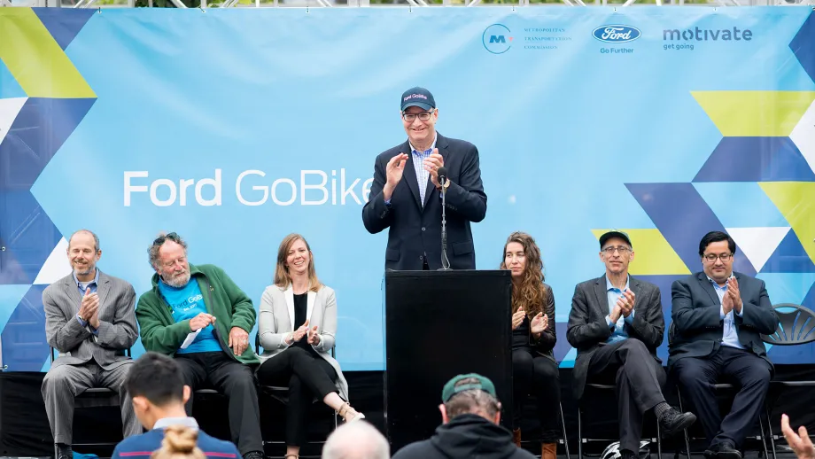 Man at podium talking to a crowd