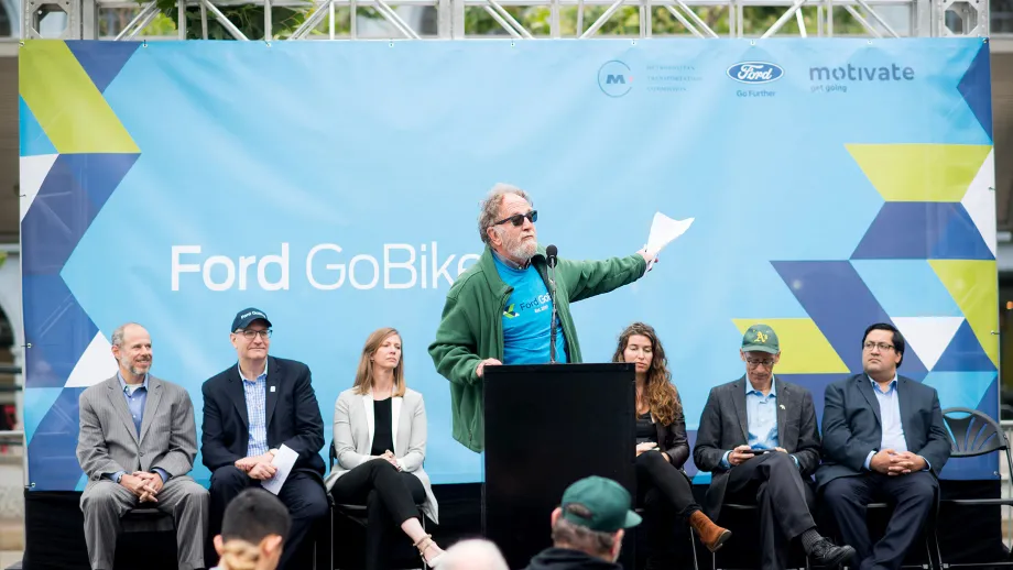 Man at podium talking to a crowd