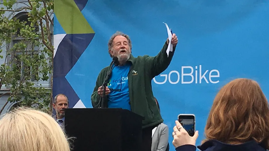 Man at podium talking to a crowd