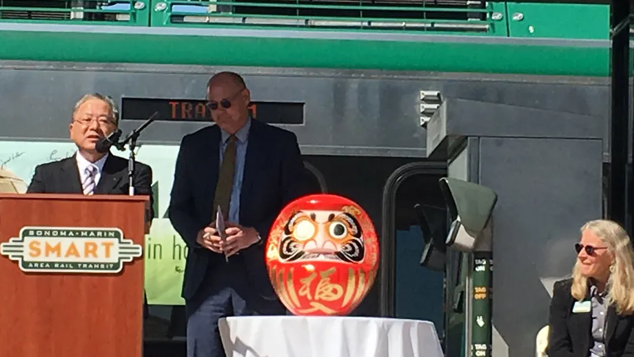 presentation of a Japanese Daruma "wish doll"