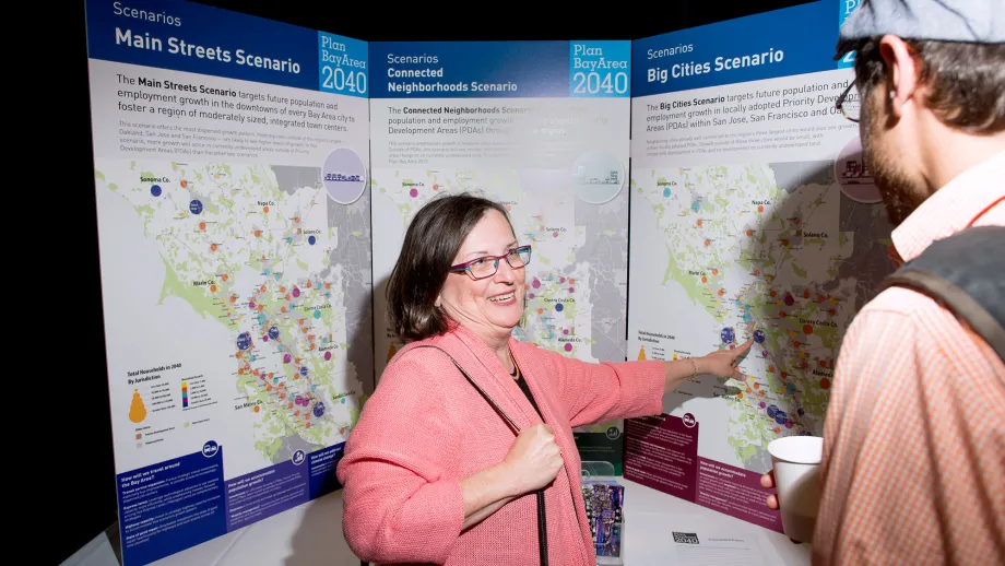 woman pointing to a display board