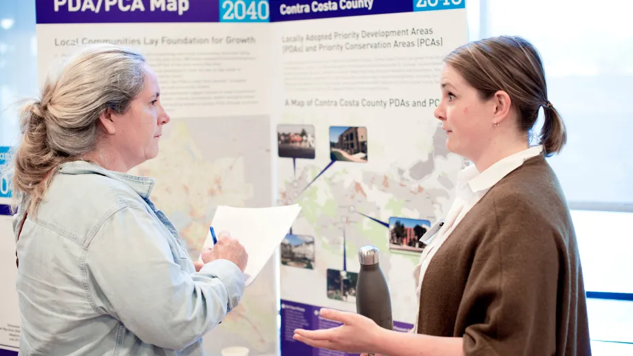 people talking in front of display boards