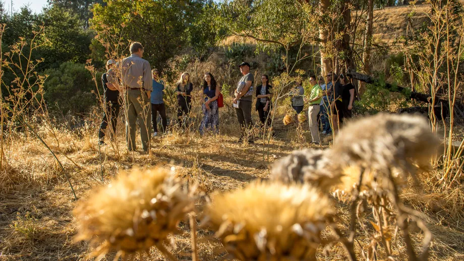 Earl Flewellen, founder of the Bull Valley Agricultural Center in Port Costa, talks with Design Team members about flood mitigation projects in Port Costa