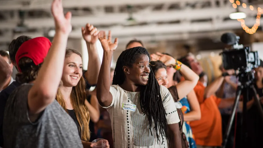 young adults raising their hands