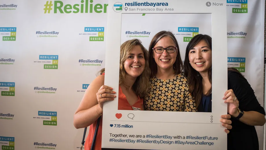 group of people posing for a picture in front of Resilient Bay backdrop