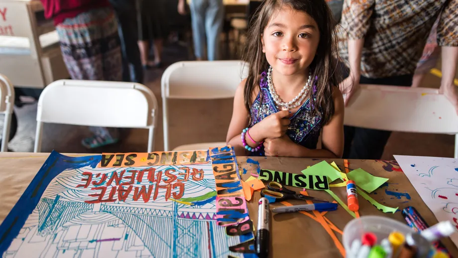 young child doing a craft at a table