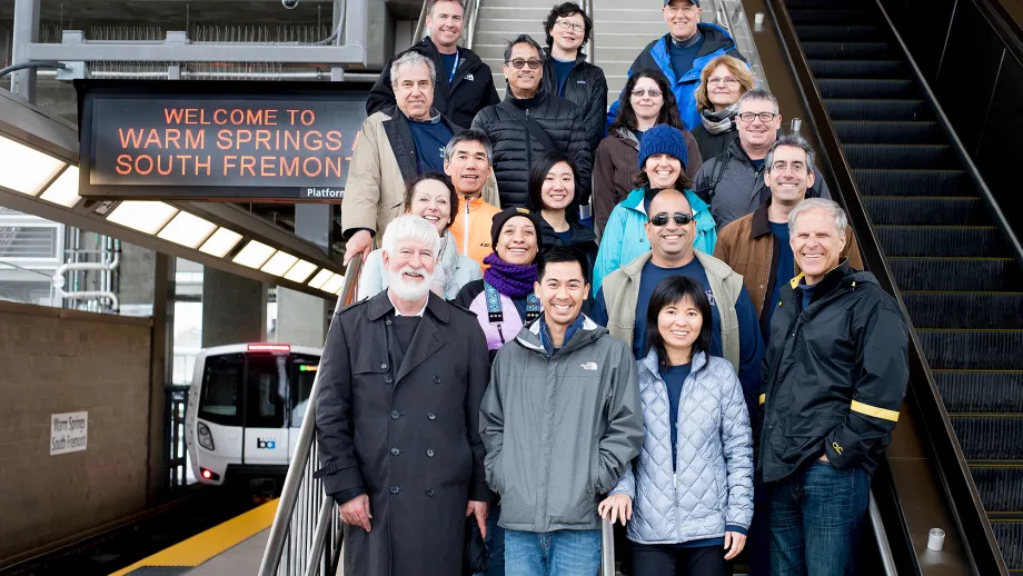 group of people posing for picture on stairs