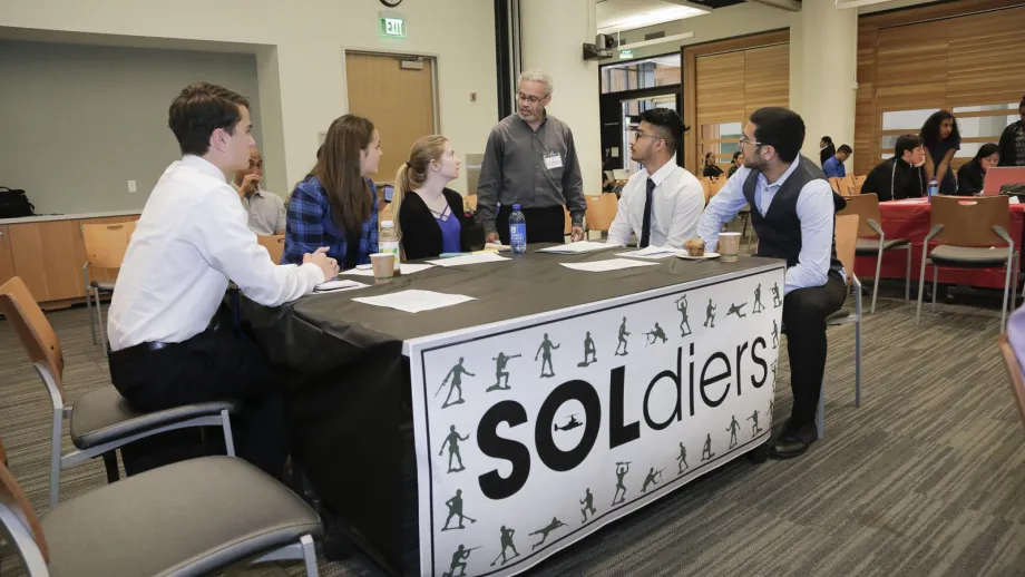 group of people at a SOLdiers table