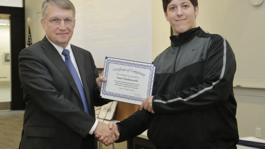 young adult being presented with an award