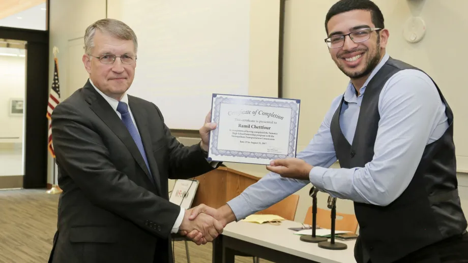 young adult being presented with an award