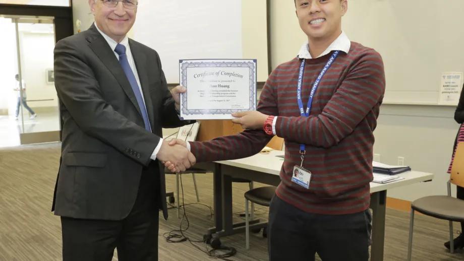 young adult being presented with an award