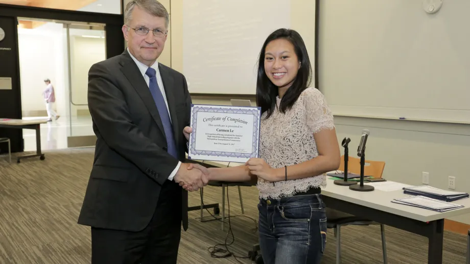 young adult being presented with an award