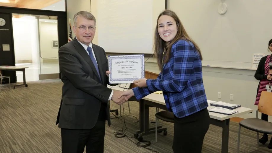 young adult being presented with an award