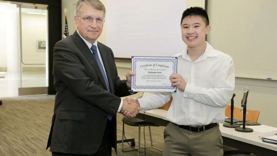 young adult being presented with an award