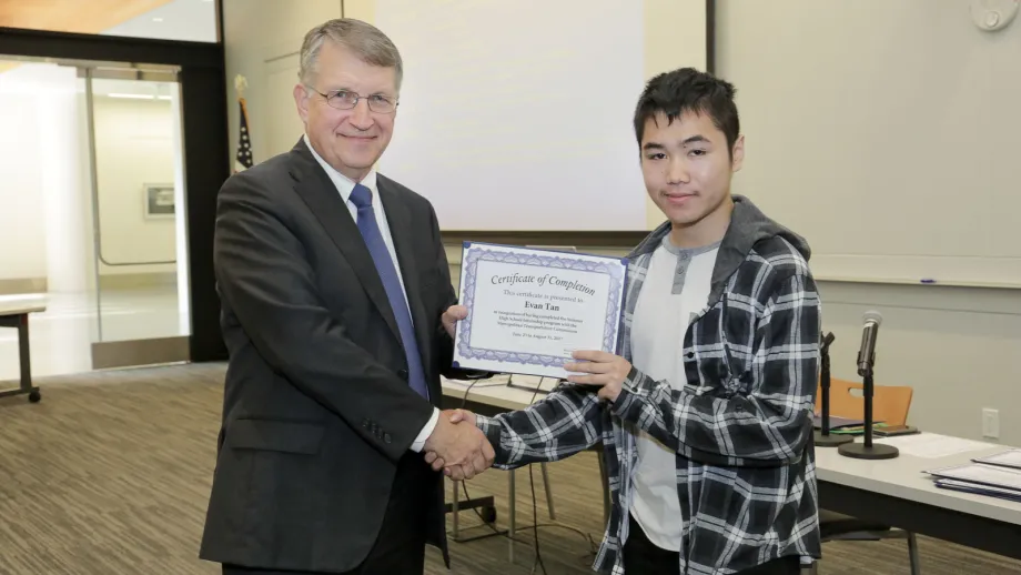 young adult being presented with an award