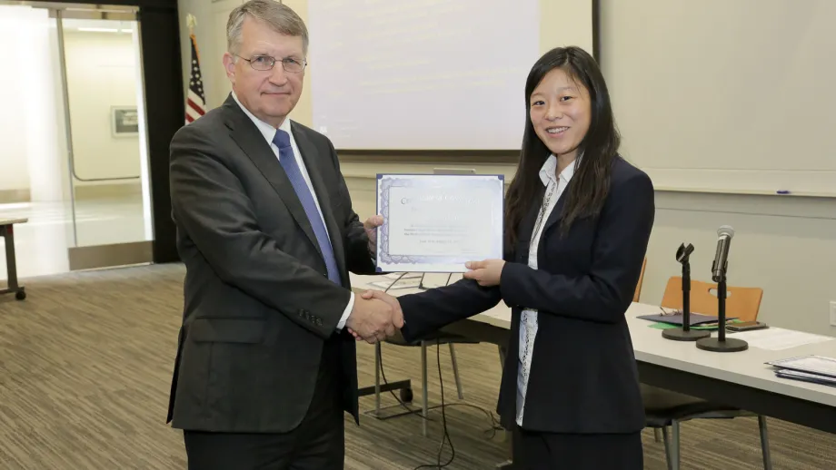 young adult being presented with an award