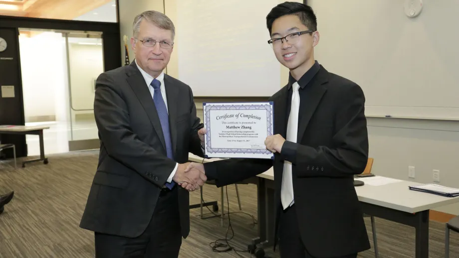 young adult being presented with an award