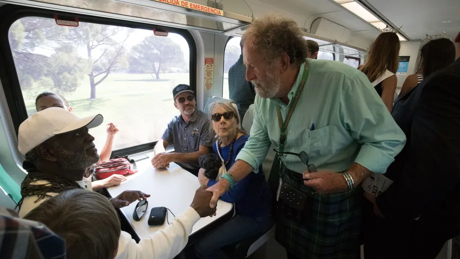 MTC Chair Jake Mackenzie greets the crowd aboard the train.