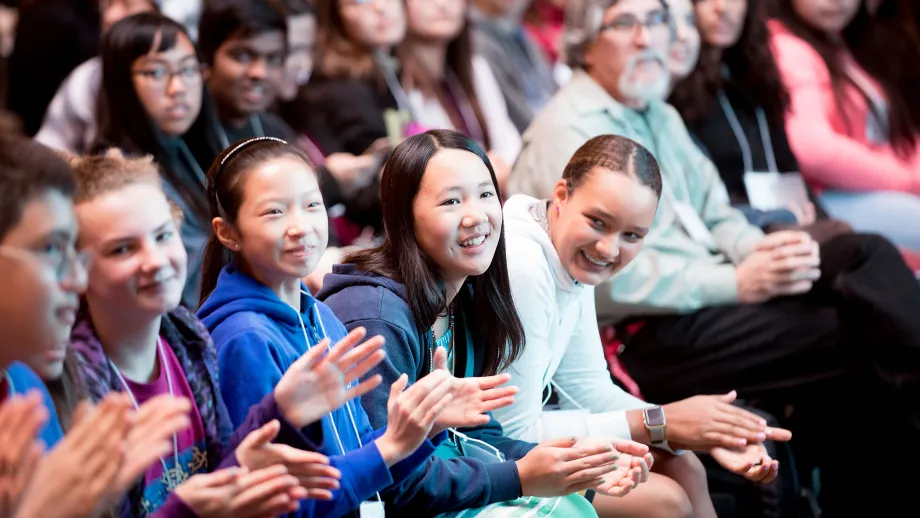 young adults clapping their hands